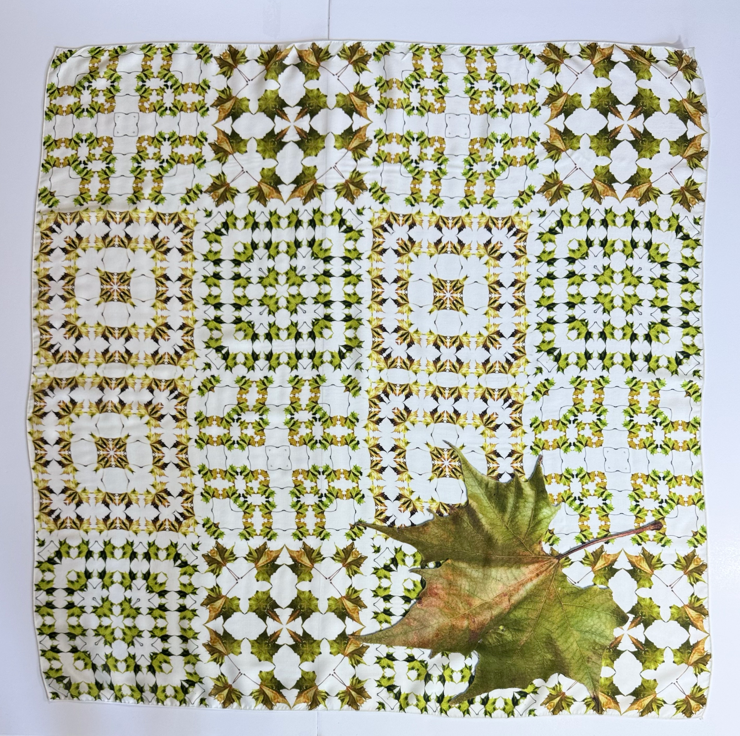 Green leaves in square patterns with a large green leaf in the corner.
