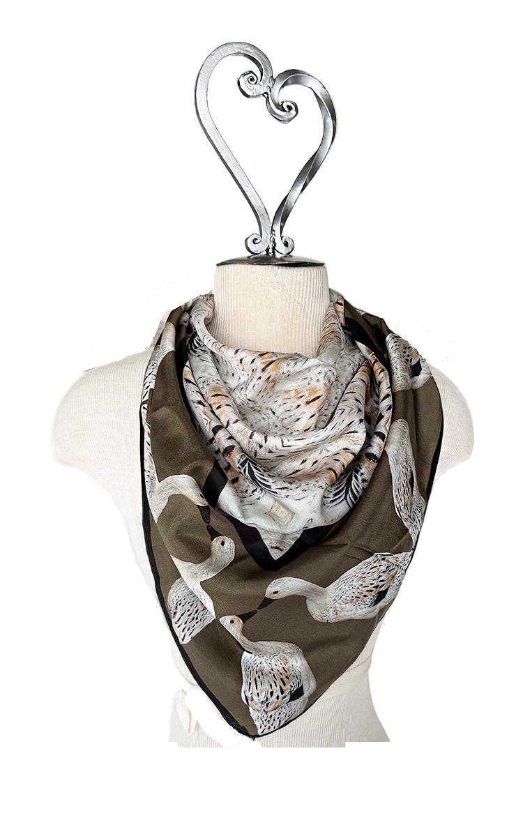 Scarf with duck pattern on a mannequin with a heart-shaped hook against a white background