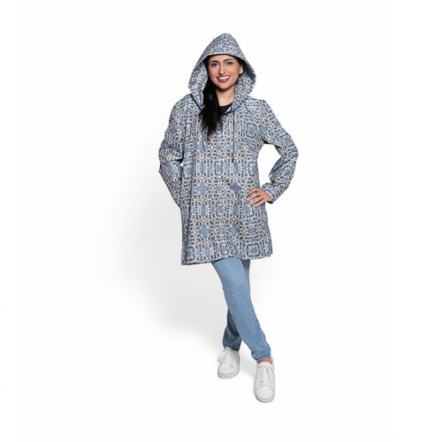 Woman wearing a patterned hooded coat on a white background