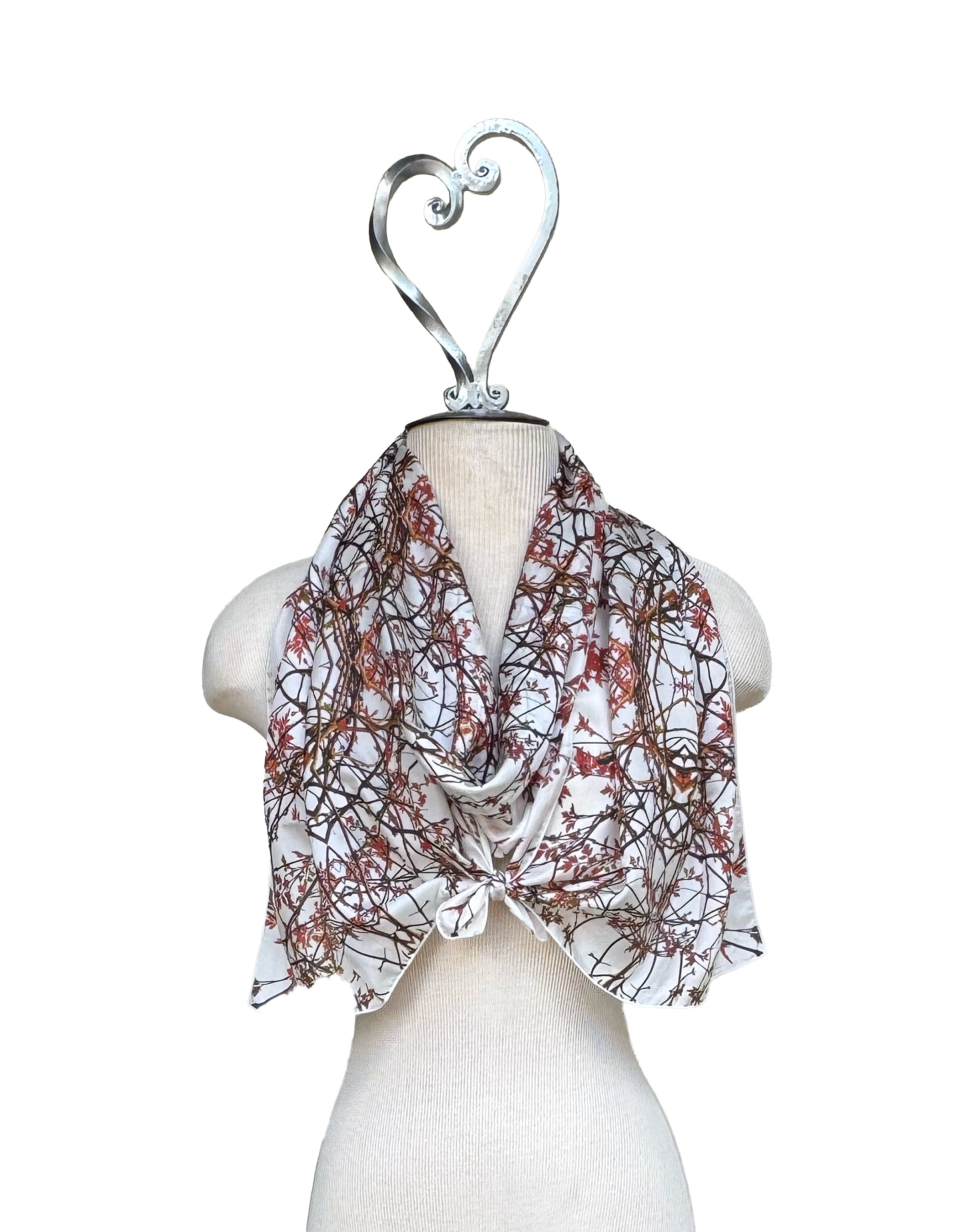 Scarf with floral pattern on a mannequin against a white background