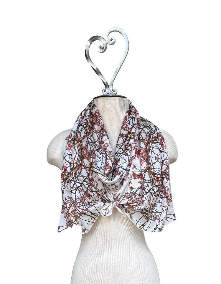 Scarf with floral pattern on a mannequin against a white background